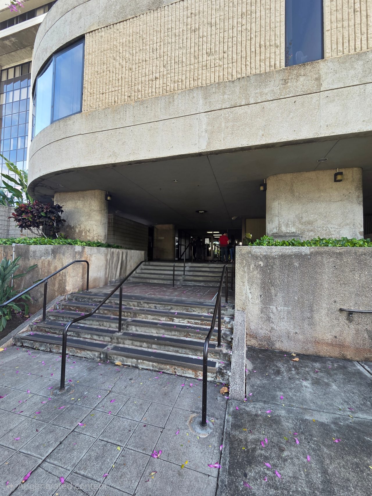 Exterior of the Honolulu Passport Agency from the concrete steps leading to the front entrance.