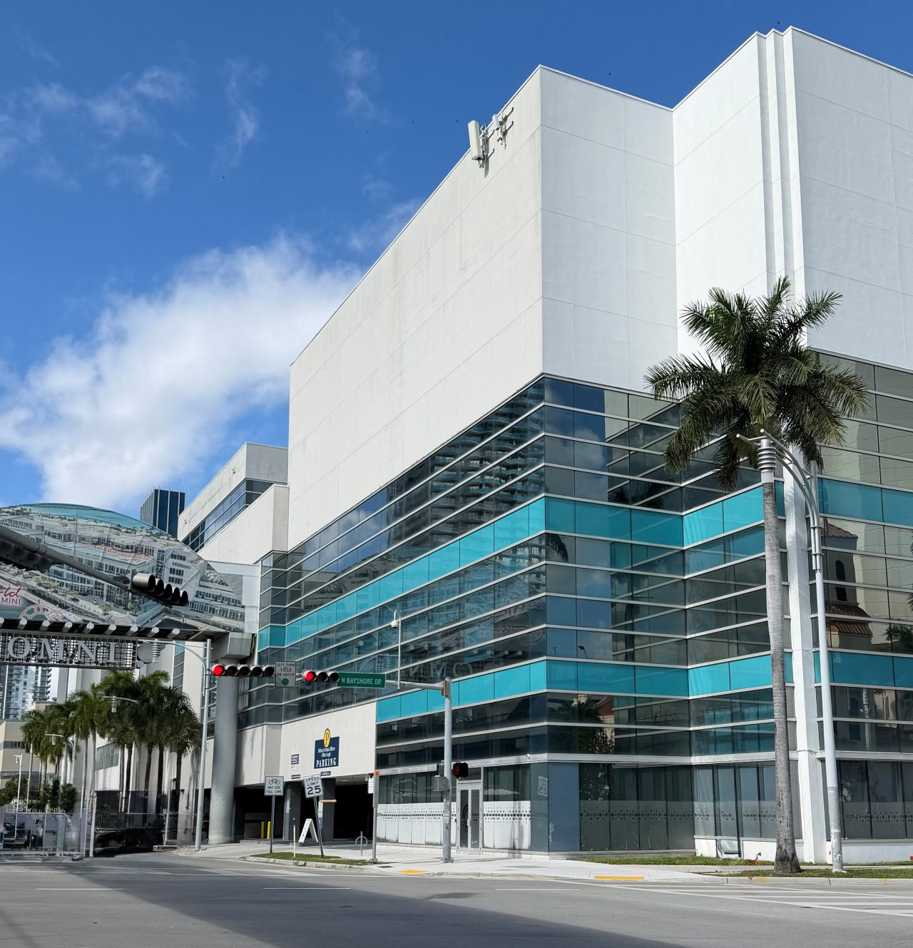 The Miami Passport Agency. The lower half of the building is lined with windows and the upper half is solid white without windows.
