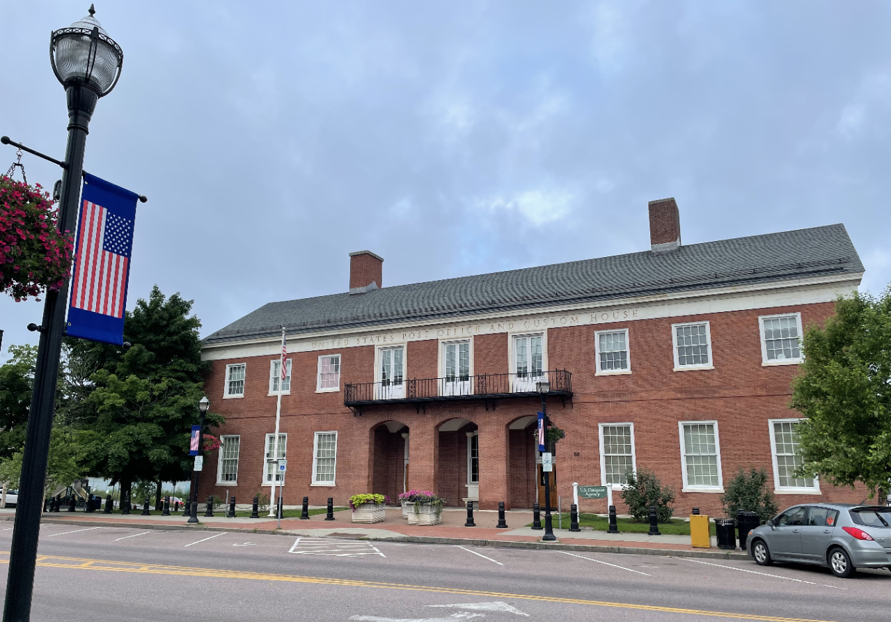 Exterior of Vermont Passport Agency building., which is a 2-story brick building.