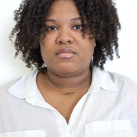 Uncentered photo of a woman with part of her head cropped out of the image..