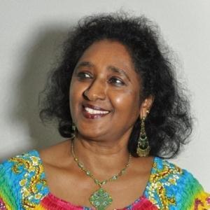 Photo of a woman with her head tilted to the side. 