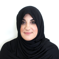 Photo of a woman wearing a head covering that blocks part of her face.