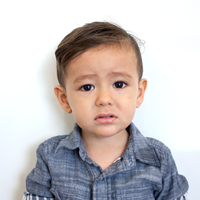 Photo of a toddler facing forward in good lighting with a neutral expression.