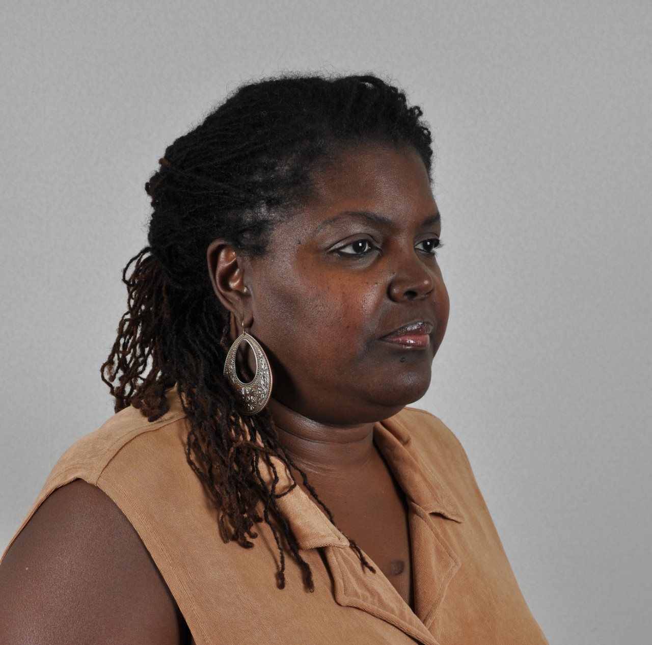 Photo of the side of a woman’s face and shoulders.