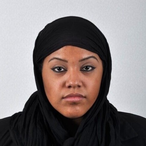 Photo of a woman wearing a religious head covering with her face fully visible.